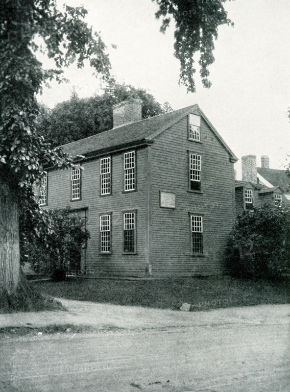 The 1920 caption reads: ""Lexington, Massachusetts, the house in which Samuel Adams and John Hancock were asleep when roused by Paul Revere."" The Hancock-Clark House in Lexington, Massachusetts, is where John Hancock and Samuel Adams were awakened by Paul Revere on April 18, 1775. The men were asleep in ""the parlor"" of the house built in 1737 by Thomas Hancock for his father Rev. John Hancock.