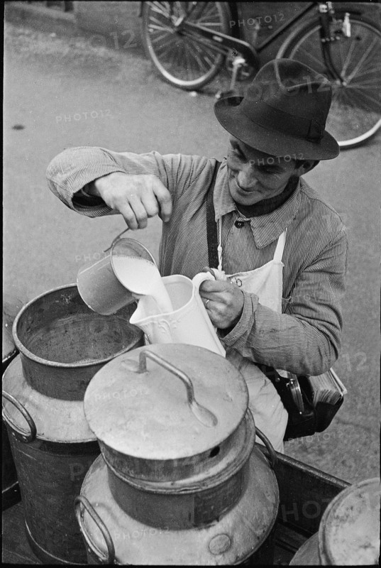 Milkman delivering milk; 1941.