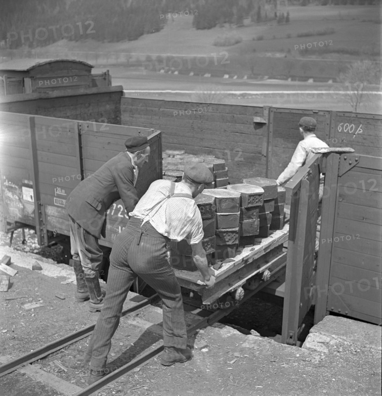 Workers loading casted asphalt in goods train; 1941.