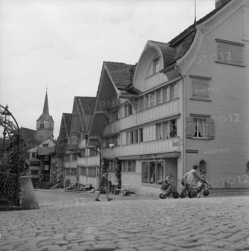 Girl on tricycle in Herisau; 1945.