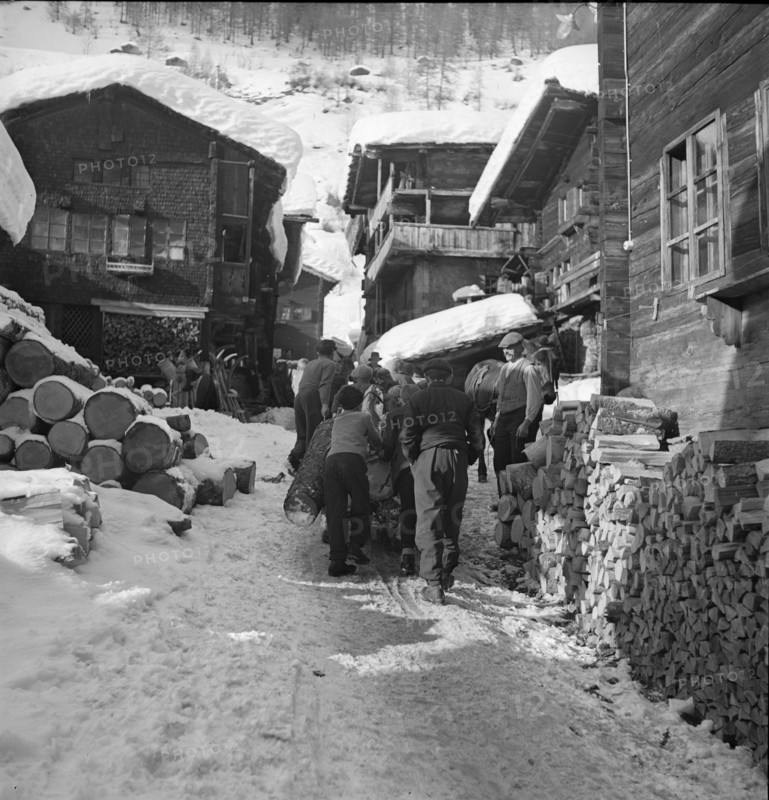 Lotschental, men transporting log;  1941.