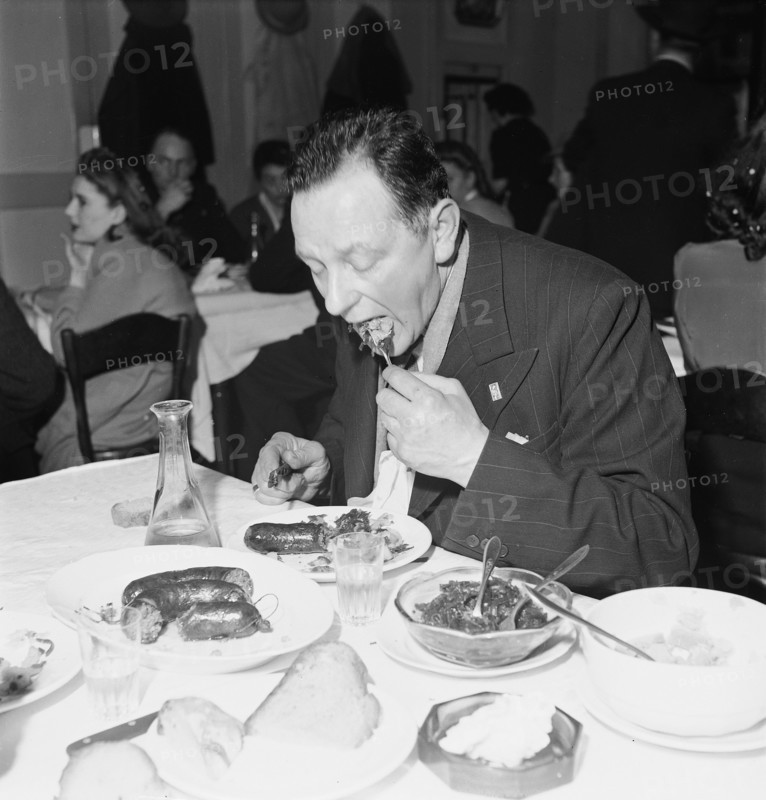 Man eating liver sausages in Payerne, 1946.
