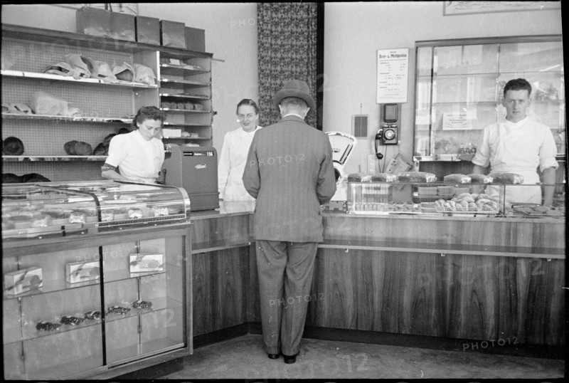 Customer in baker's shop; around 1940.