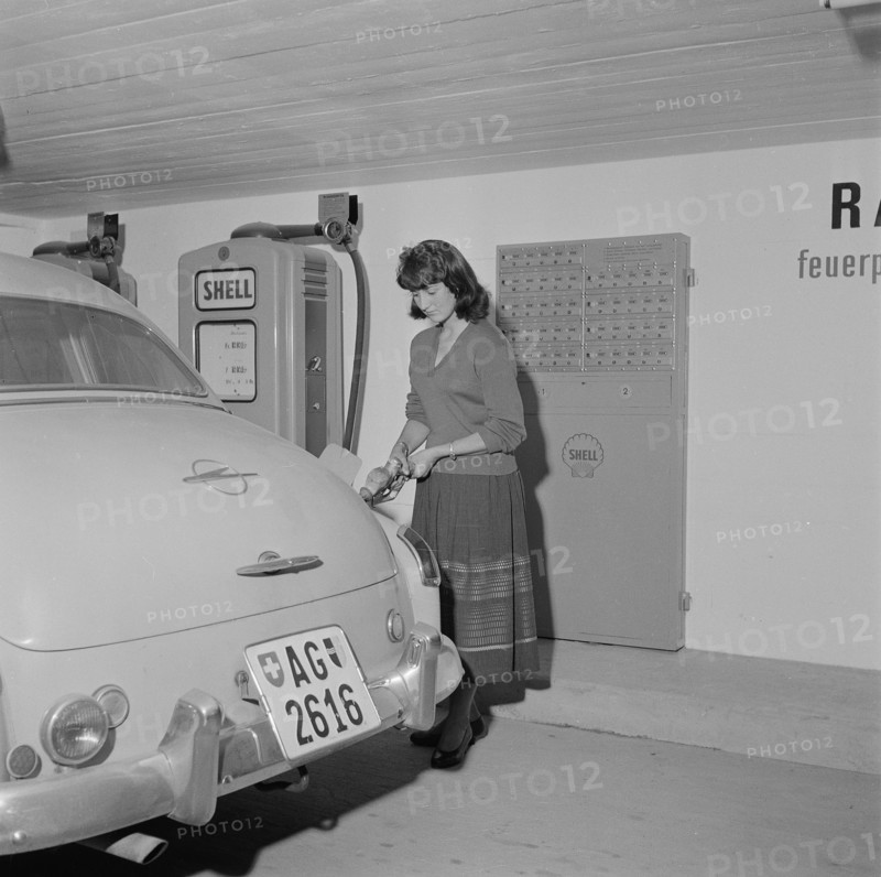 Woman fills up Gasoline at Self Service Gas Station, 1956.