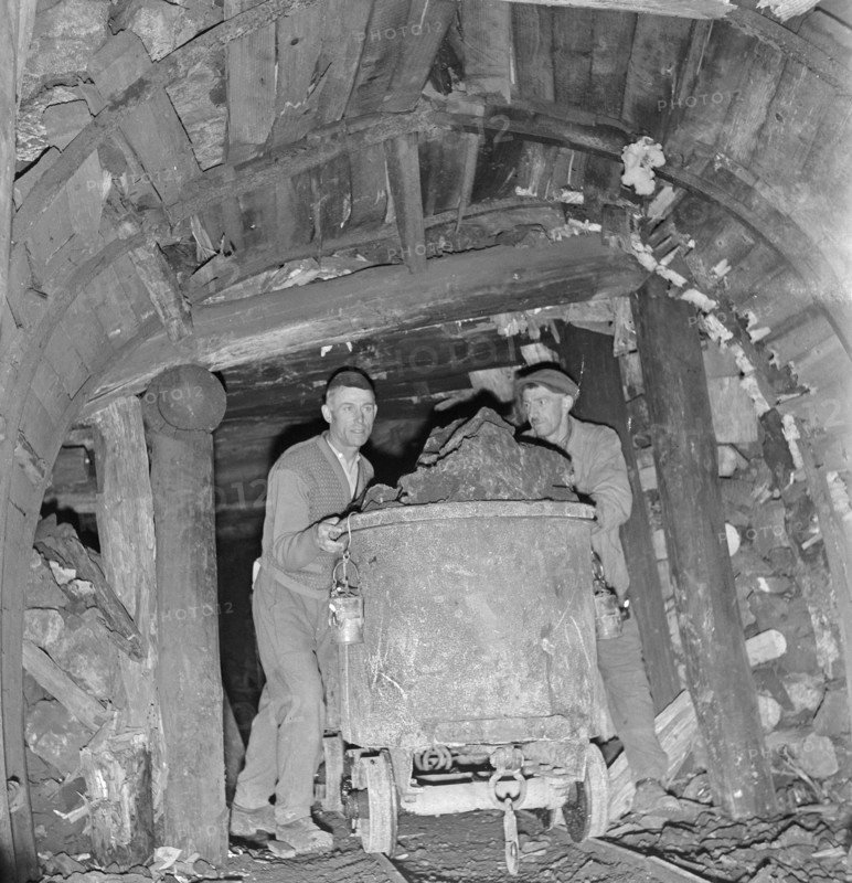Asphalt mine; miners pushing mine car; 1941.