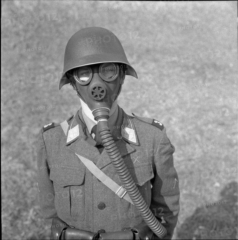 Swiss soldier in gas mask and helmet 1958