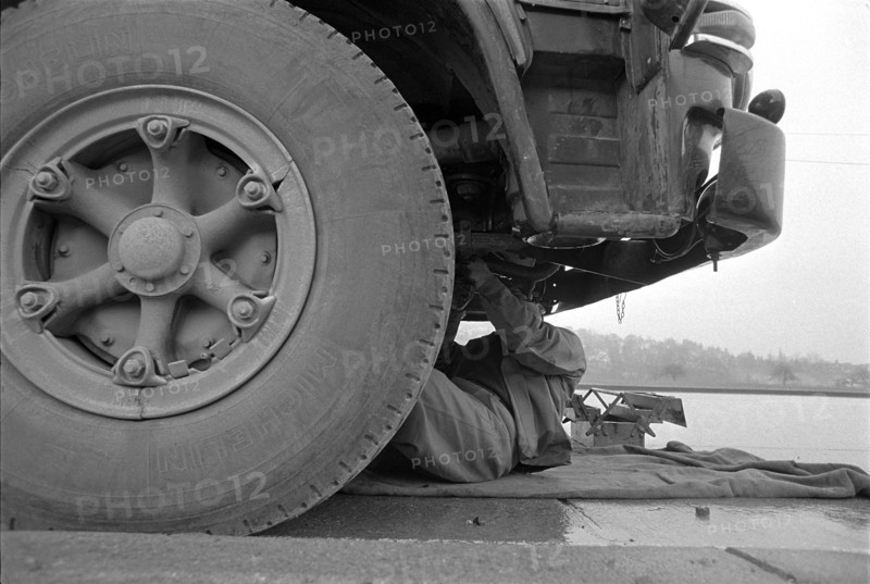 Driver on the road running truck repair; 1967