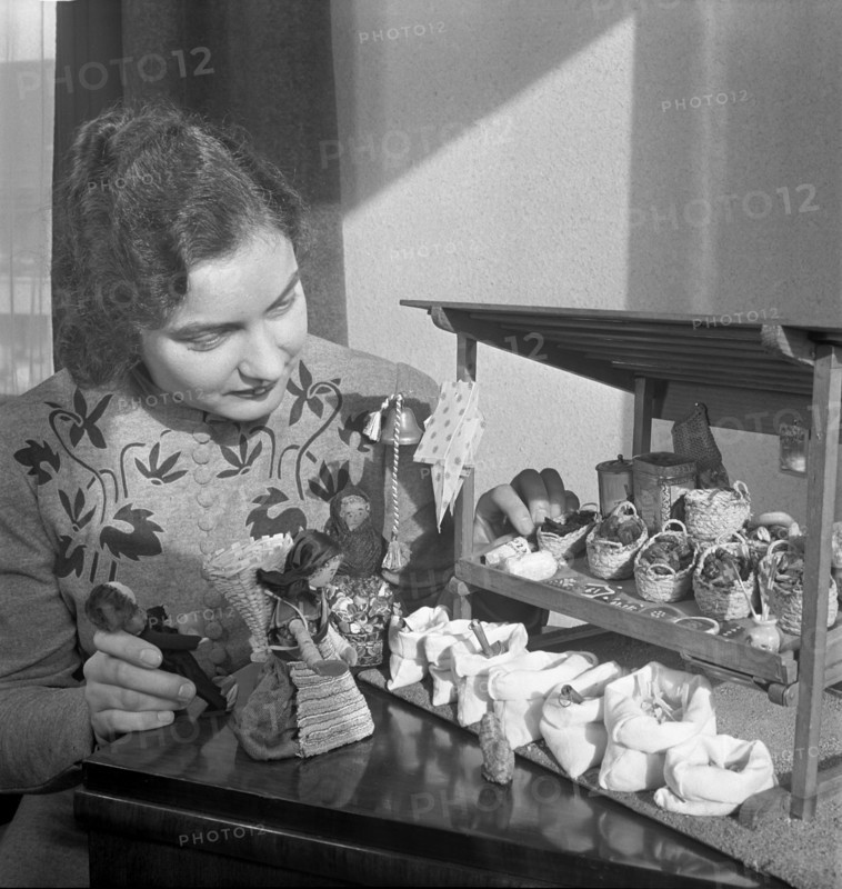 Woman making a market stall for children, 1941