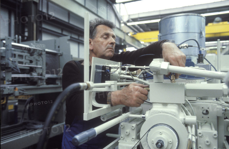 Worker assembling injection molding machine 1986