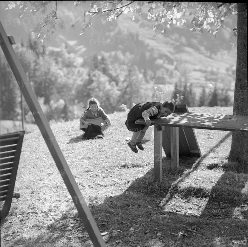 Tibetan child climbing on table, underwater 1961