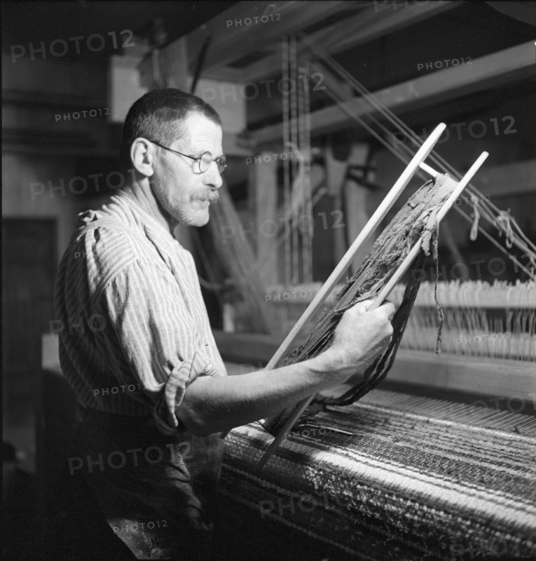 Man weaving a carpet, 1940