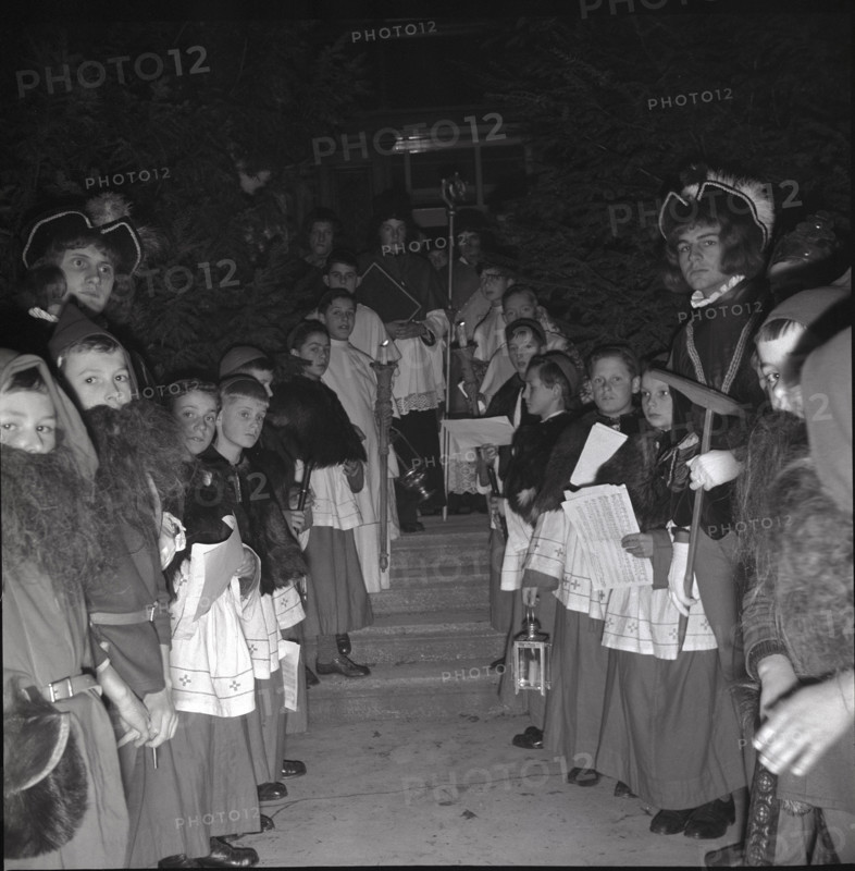 Children in historical costumes wait for Santa Claus in 1941
