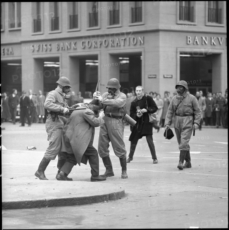 Policemen bashing demonstrator; 1961