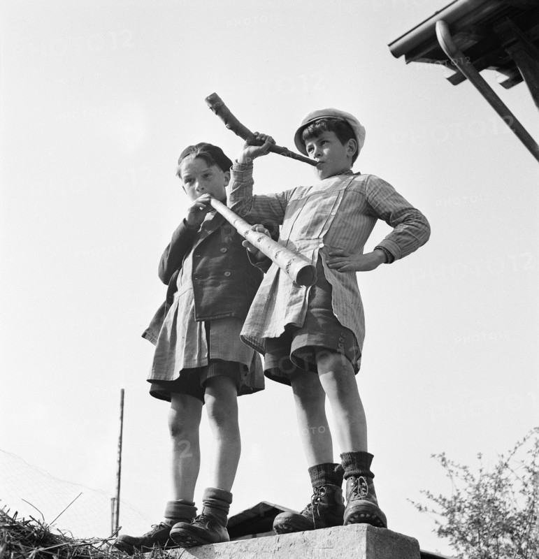 Boy playing the horn on the day of Feuillu, 1944