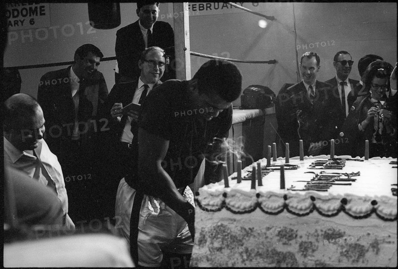 Muhammad Ali, born Cassius Marcellus Clay Jr. with gateau for 25th birthday, Houston 1967