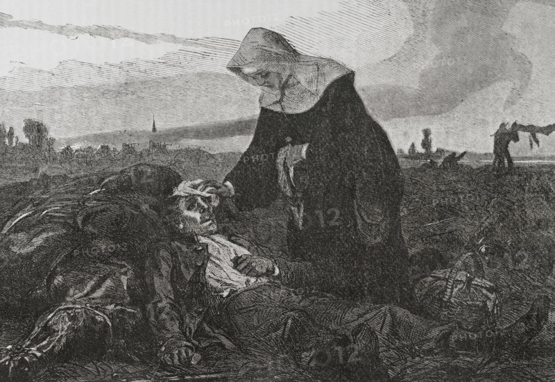 Franco-Prussian War (1870-1871). Sisters of Charity on the battlefield, tending to the wounded. Engraving. ""Historia de la Guerra de Francia y Prusia"" (History of the War between France and Prussia). Volume I. Published in Barcelona, 1870.