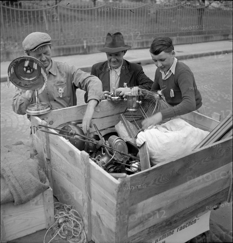 Men collecting nonferrous metal, handcart; 1942