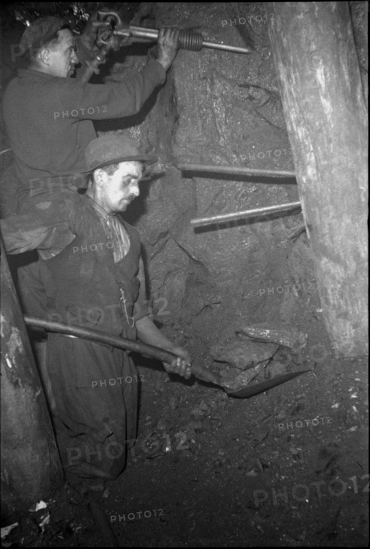 Miners in the tunnel; preparing the blast hole; 1942