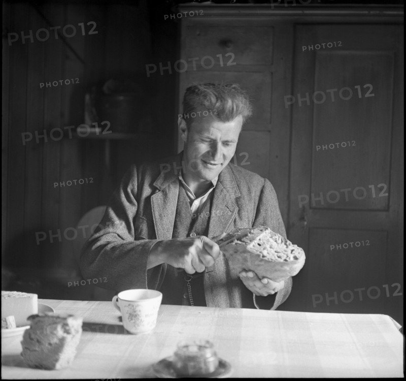Farmer cutting bread, 1941