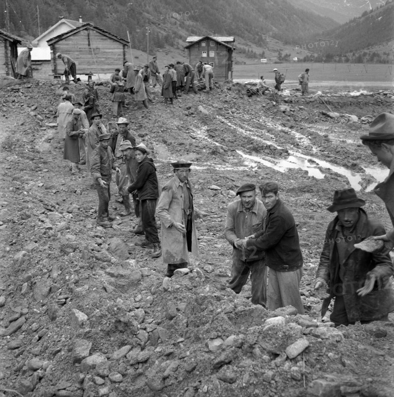 Men doing cleanup work in the Valais village of Täsch; 1957