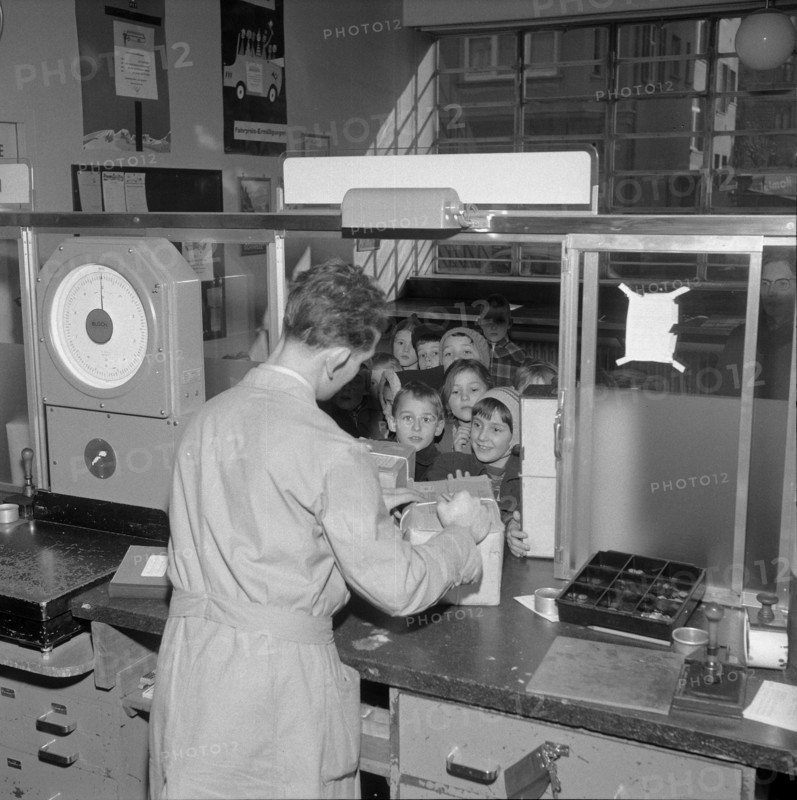 Postal worker accepting parcels from children, Zurich 1956