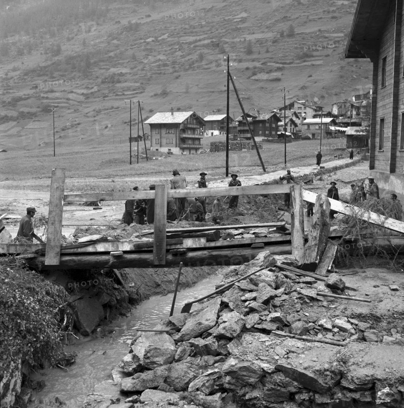 Clearance work after flood in the valais village Täsch. . 1957