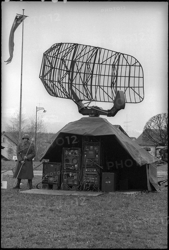Soldier with parabolic antenna of anti-aircraft defence, Emmen 1965