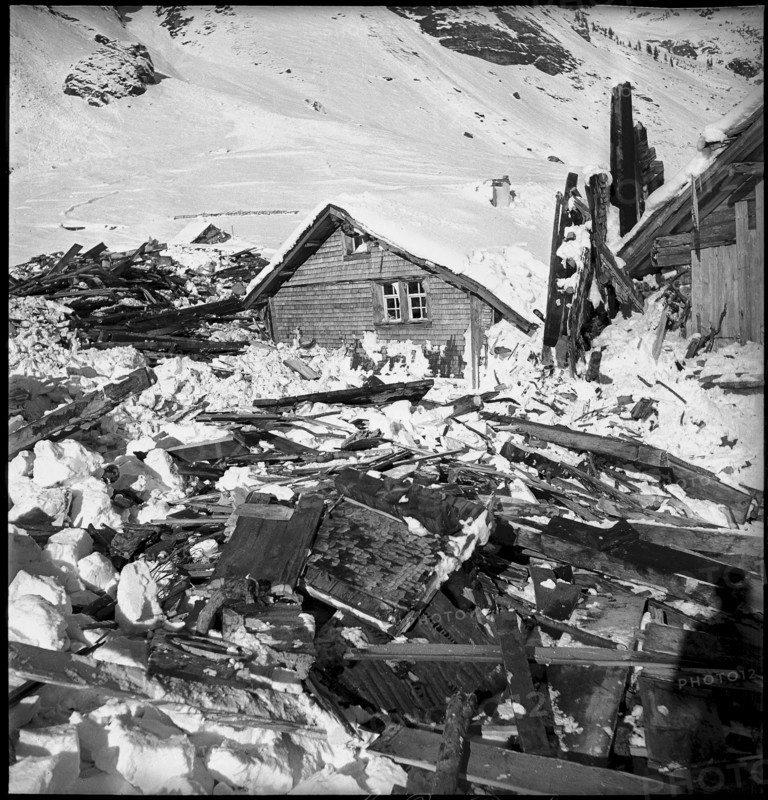 Urnerboden: people searching among the remains of buildings destroyed by an avalanche, 1940