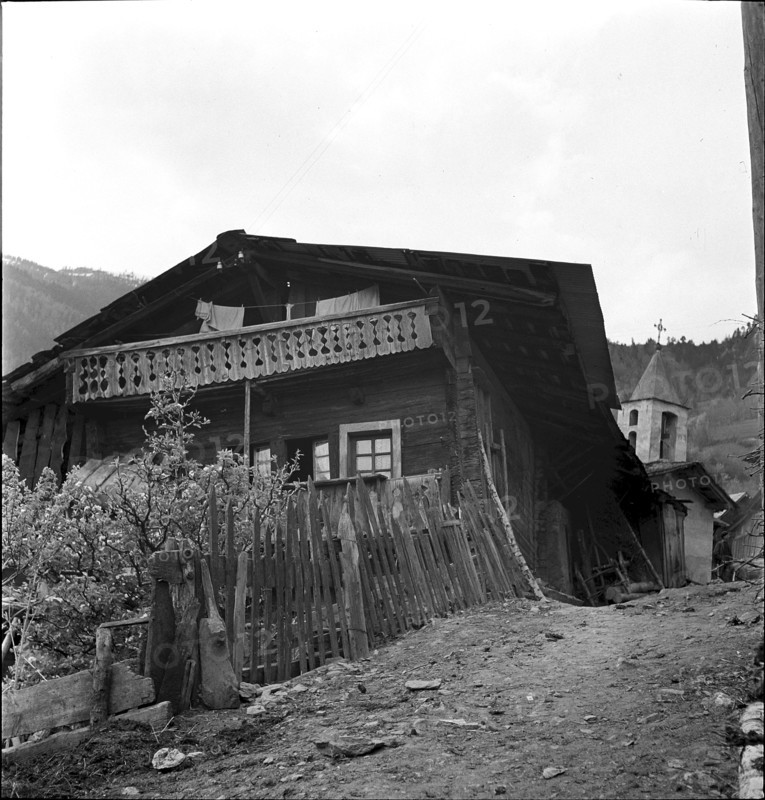 Muhen, man and boys in front of traditional thatched house, 1942