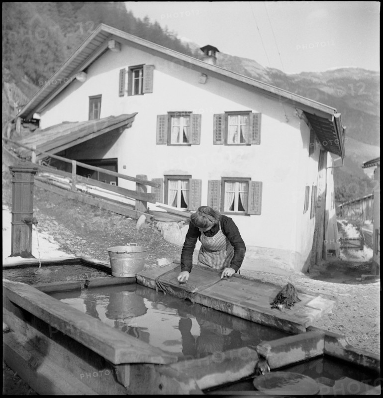 Woman washing clothes at the fountain, 1946