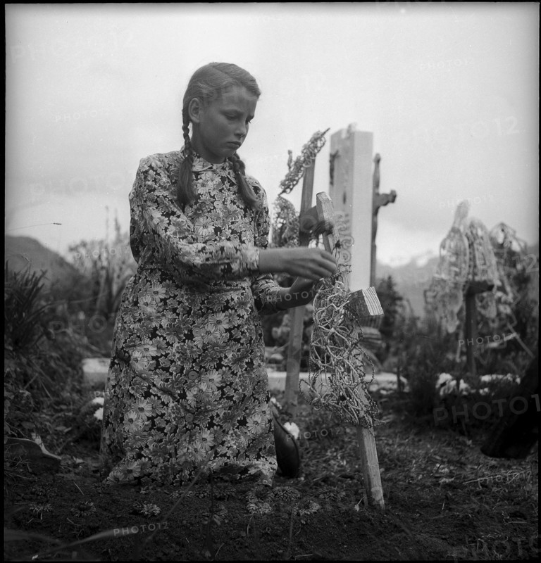 Girl decorates grave on All Souls' Day, 1945