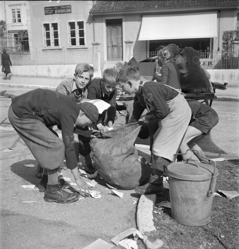 W K 2: war economics; young people collecting material to be recycled.