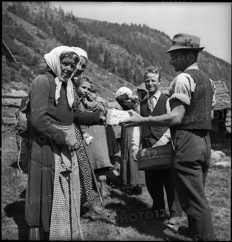 Cheese donation in the Turtmanntal valley, Switzerland, 1940.