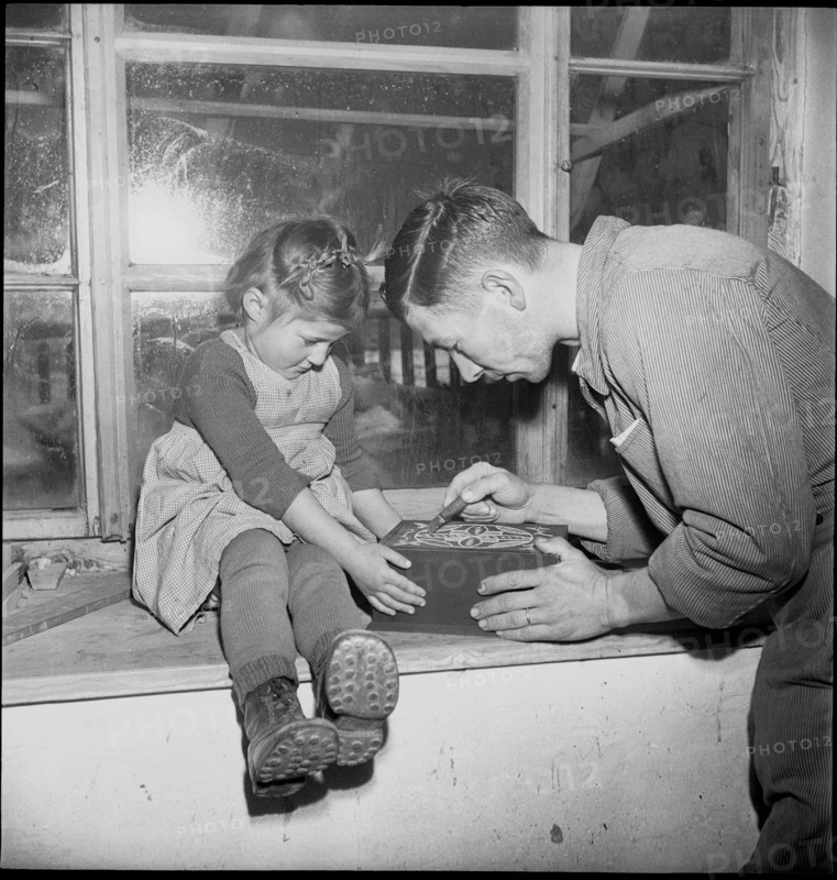Man ornamenting a small box, 1946.