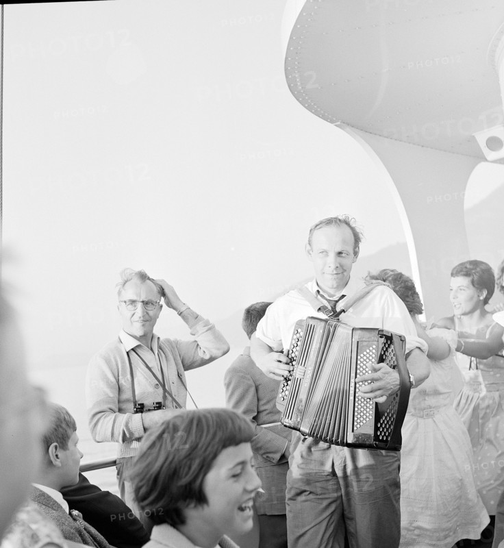 national holiday: Man playing accordeon, young people dancing; 1962.