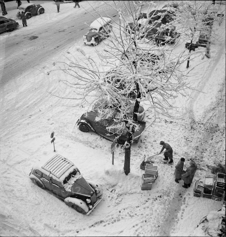 Snowfall in Lausanne: snowy street; 1952.