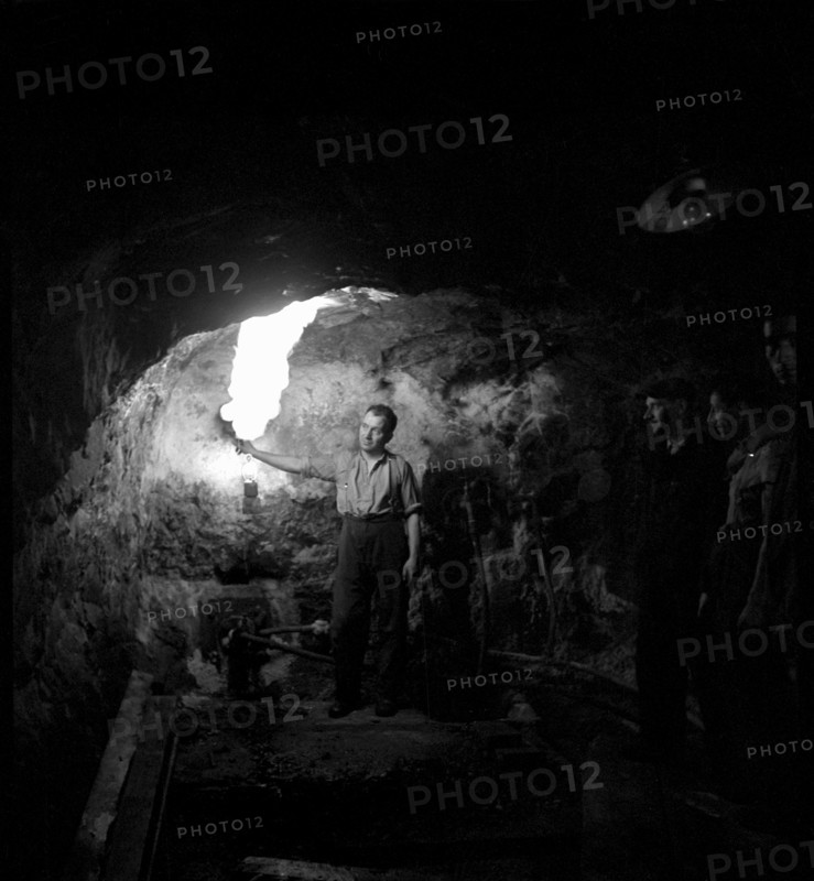 Worker in a gallery of the Bex salt mine, salt works; 1940.