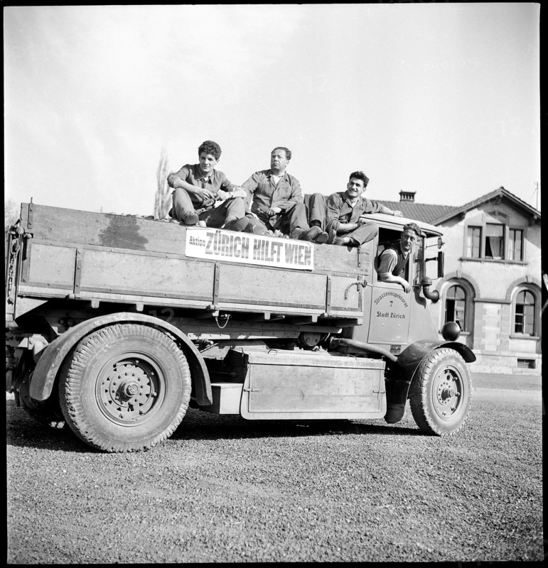 Men on truck to transport the collected potatoes.