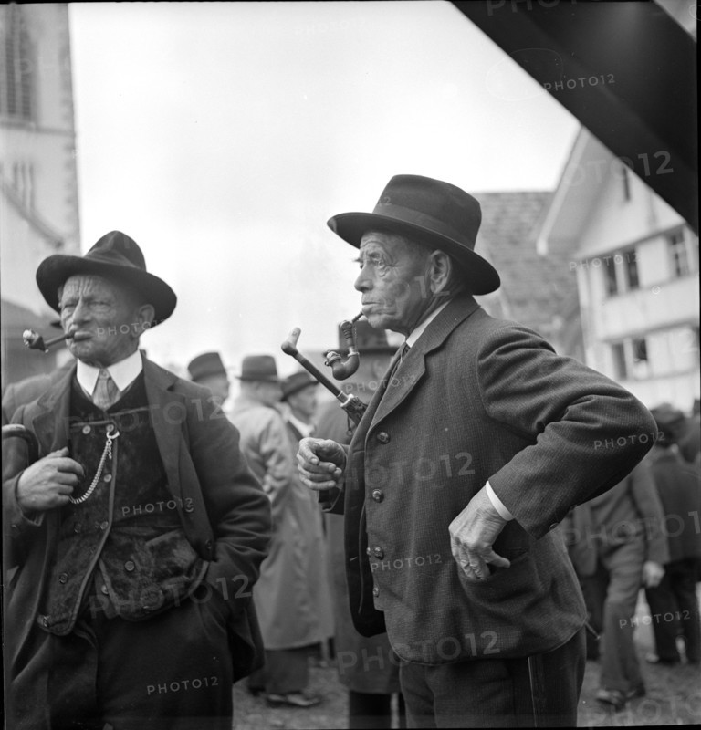 Men smoke a pipe at the voter`s meeting Hundwil around 1945.