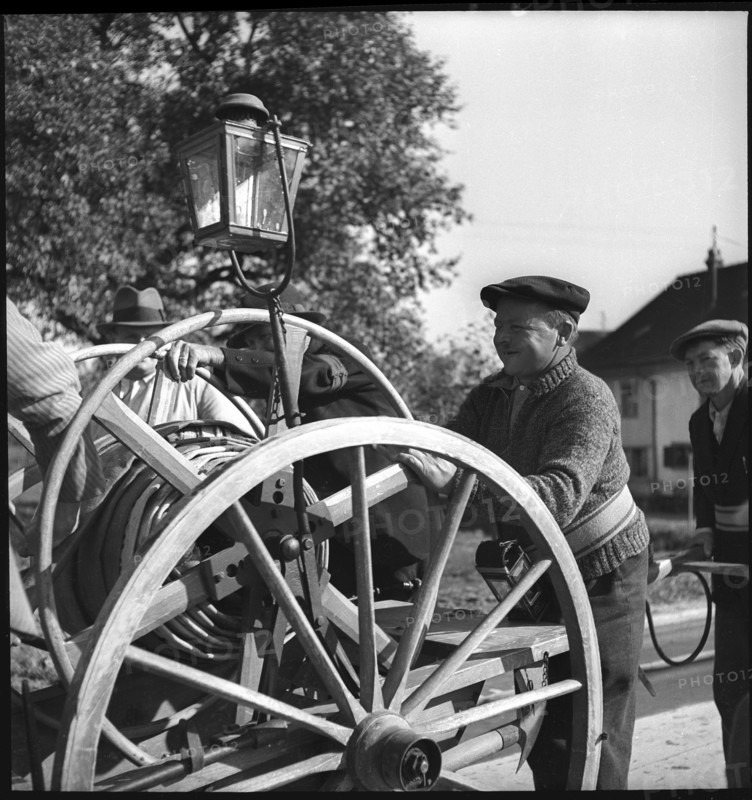 War fire brigade: men with hose cart, 1939.