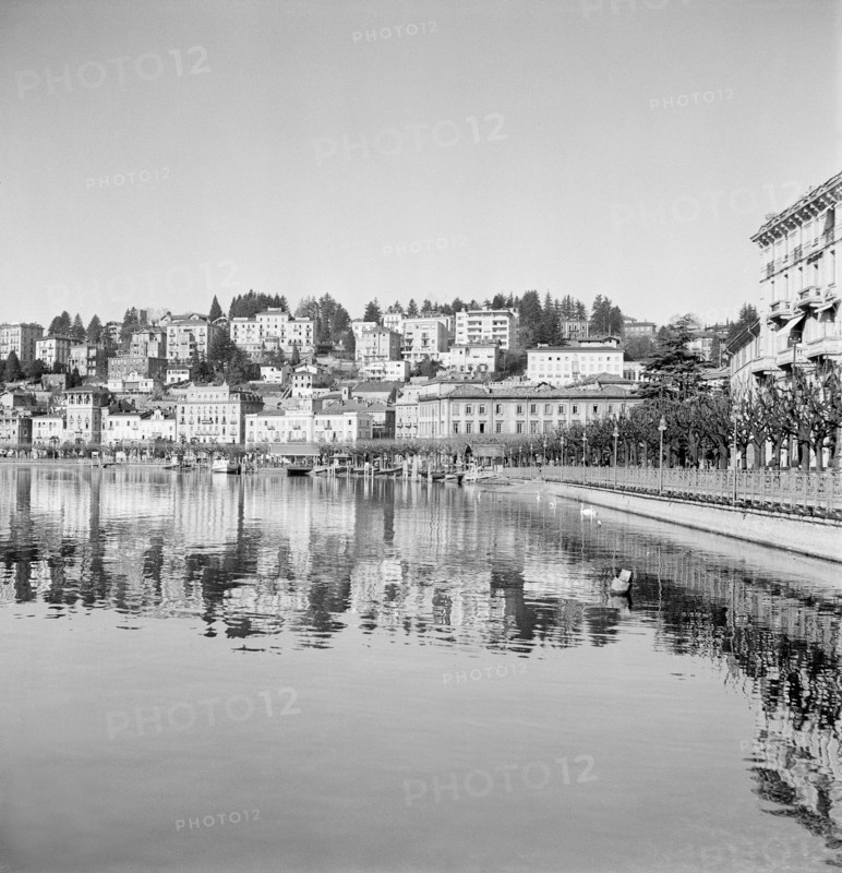 Lugano: buildings are reflected in the water of Lake Lugano, 1940.