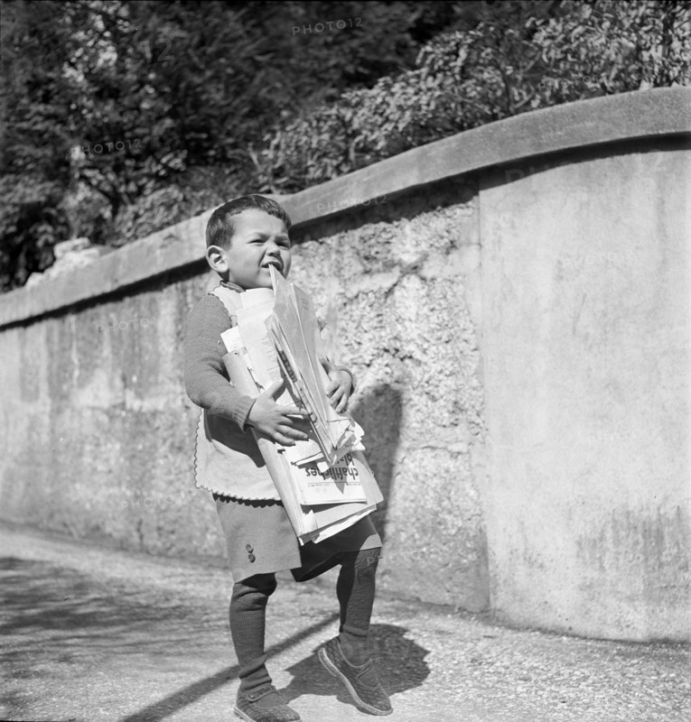 WW 2: war economy; boy carrying waste, used paper.