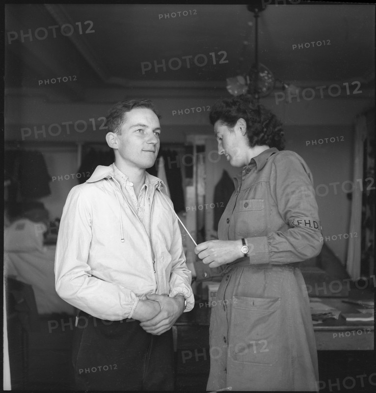 Refugee trying clothes on, 1945.