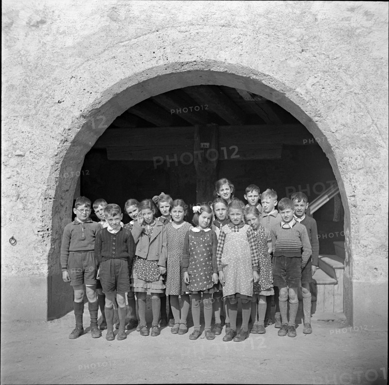 Children posing for photographer; 1941.