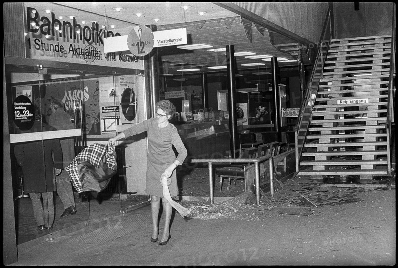 Bomb attack in Zurich mainstation; woman shaking out broken pieces of her clothes 1971.