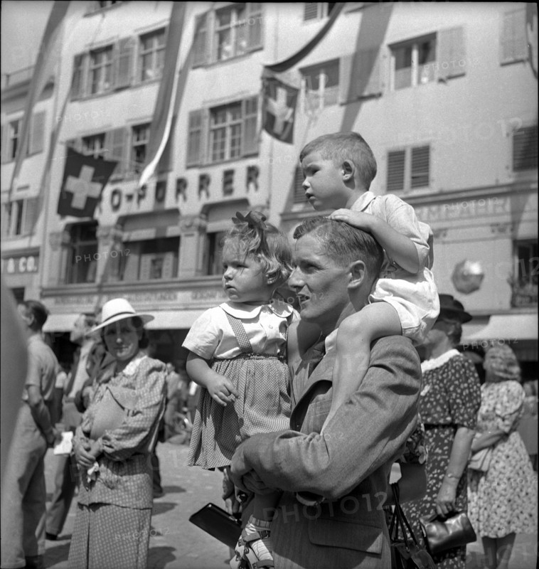 Zurich, National Holiday celebration, man with two children;  1943.