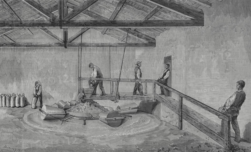 Madrid, Spain. New gypsum mill, Montenegro system, established in Vallecas, in the facilities of Messrs. Rous. The engineer Antonio Montenegro designed a grinding system to obtain a high quality gypsum, without residues, which could be packaged directly as it came out of the mill. Some workers take the stone up the ramp, others enter the clay through the door, to pour it all into the hopper on the bridge. The mechanism for the powerful transmission of the movement required by this system is subway, with easy access for maintenance and lubrication. Engraving by Bernardo Rico (1825-1894). The Spanish and American Illustration (La Ilustracion Espanola y Americana), 1883.