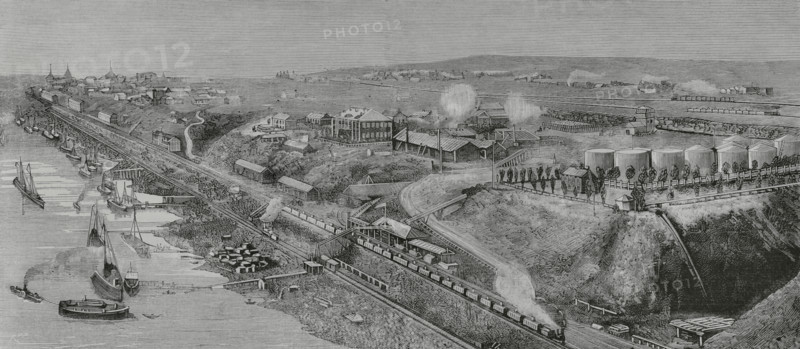 Tsaritsyn (present-day Volgograd), Russia. General view of the port and town. Storage tanks of refined oil from the Baku oil fields. Engraving by Bernardo Rico (1825-1894). The Spanish and American Illustration (La Ilustracion Espanola y Americana), 1884.