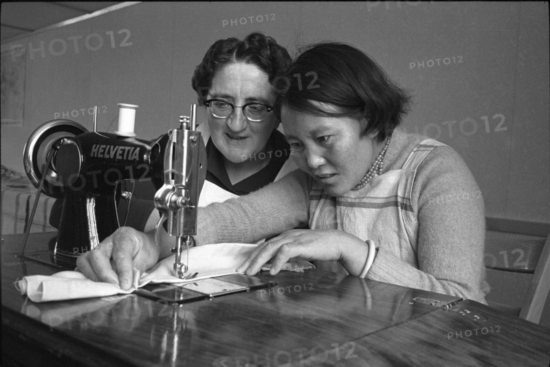 Tibetan woman learning to sew by sewing machine, Waldstatt 1962.