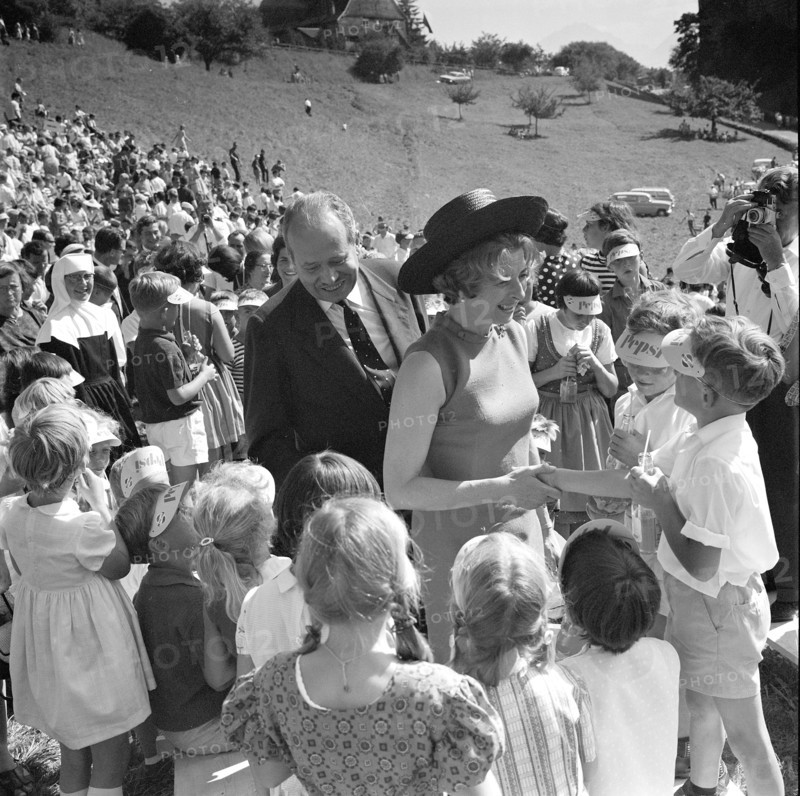 The Prince and his wife surrounded by children.